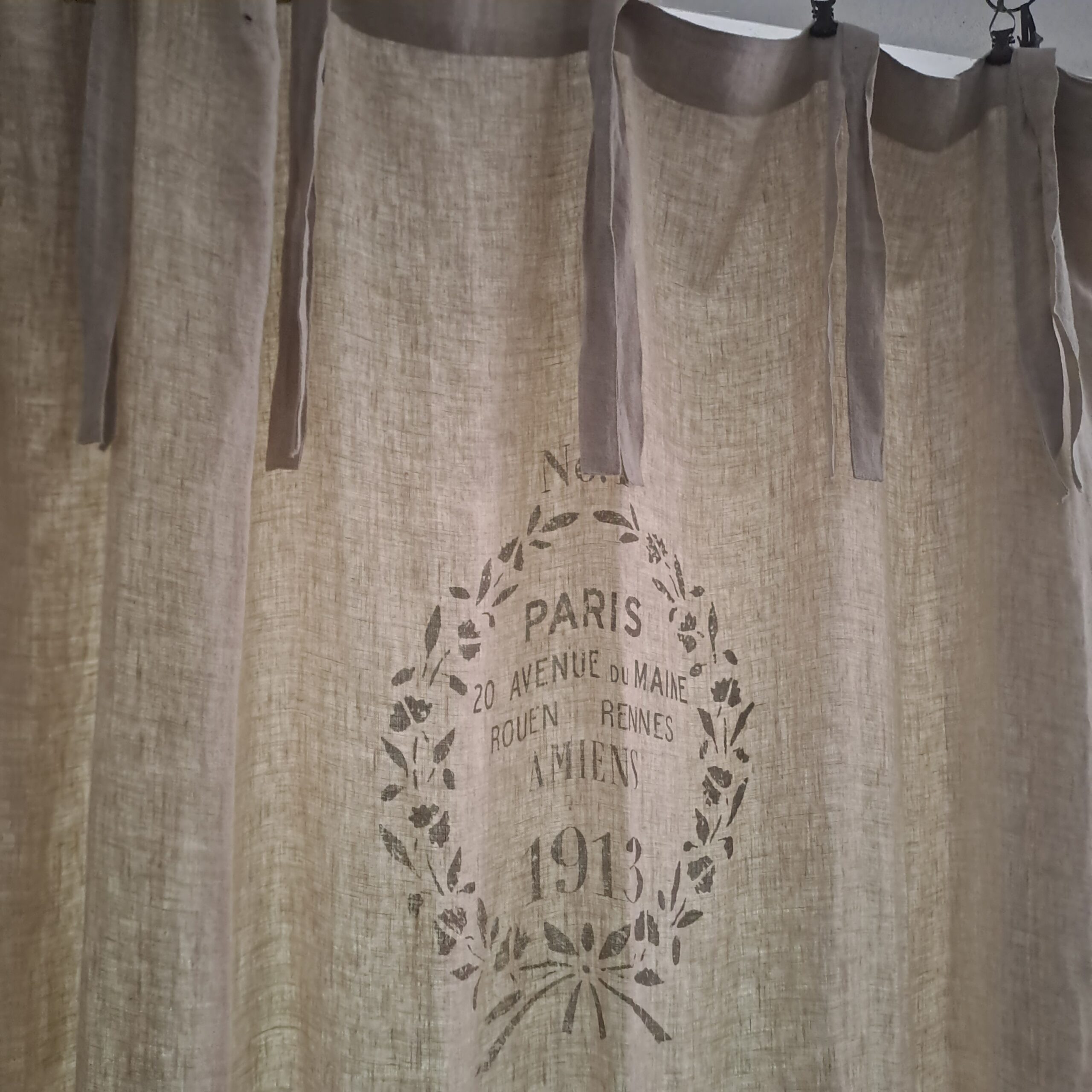 Cremefarbene JDL Gardine Amiens Paris 140x220 cm aus Leinen mit Vintage‑Print und 7 Schlaufen zum Binden.